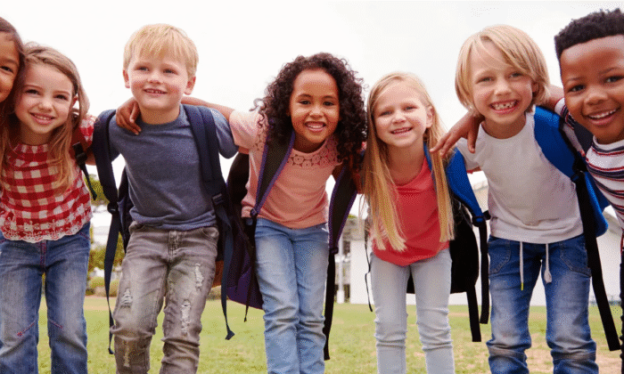 Kids with backpacks in a huddle