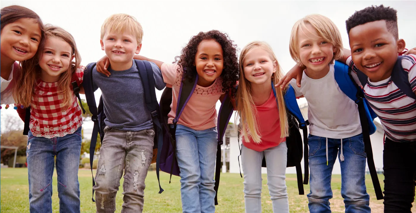 Kids with backpacks in a huddle