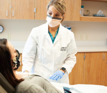 Laila Rashidi, MD, FACS, FACRS, with patient