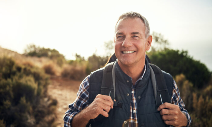 Shot of a mature man hiking through the mountains