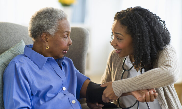Nurse taking woman's blood pressure