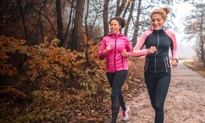 Two women jogging on a fall day