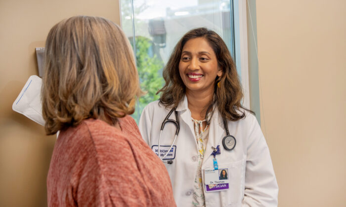 A doctor smiling at her patient.