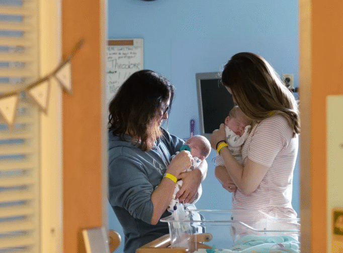 Two women holding babies.