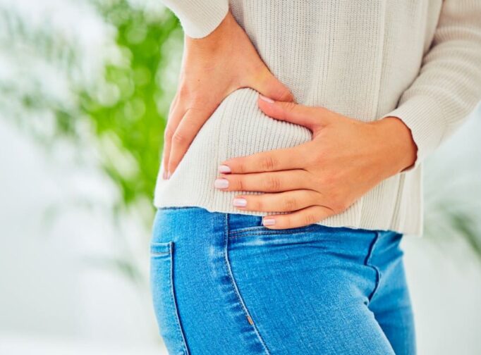 Person holding aching hip