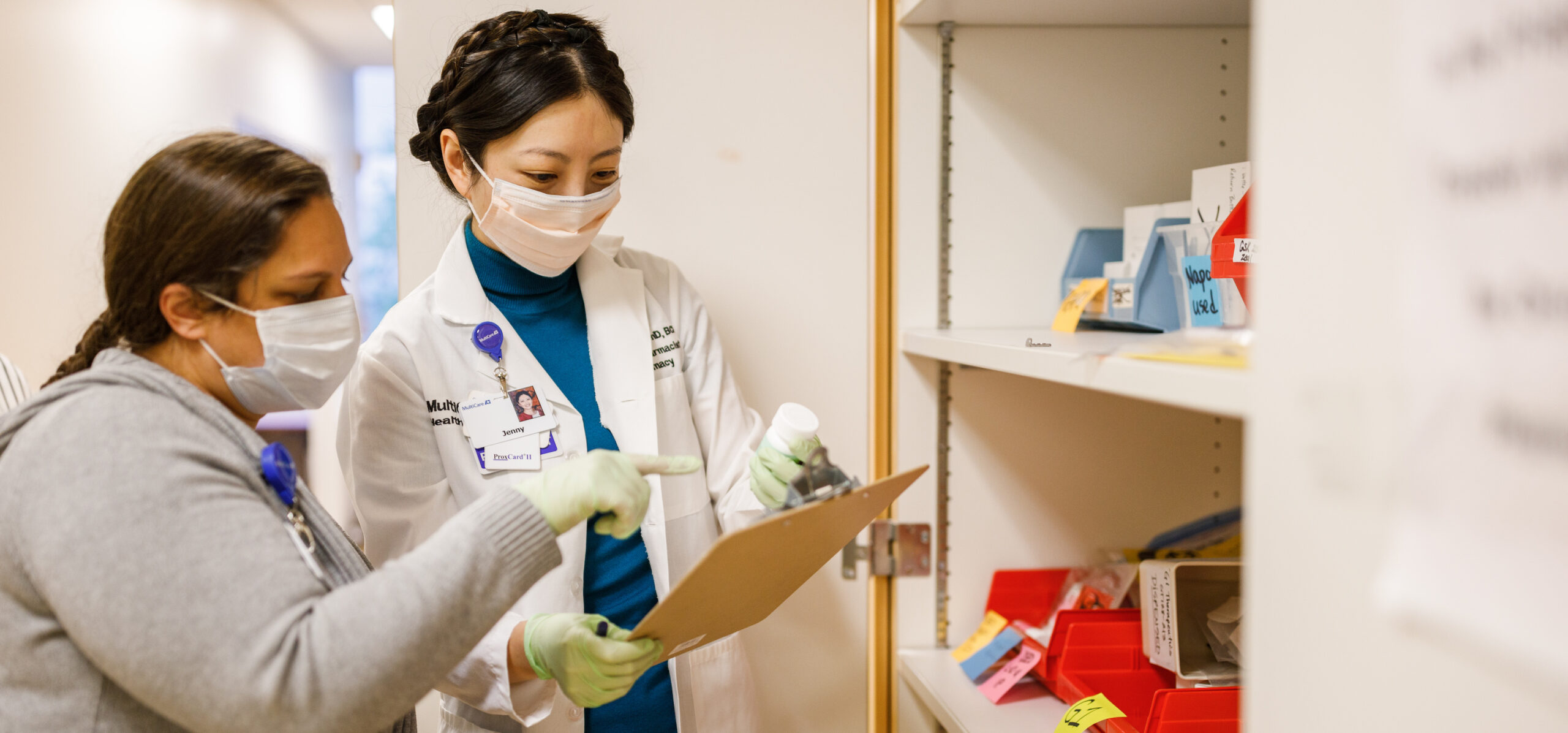 Clinical staff reviewing information on a clipboard