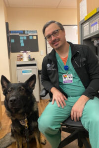 James Raspanti in clinic with German Shephard at his side