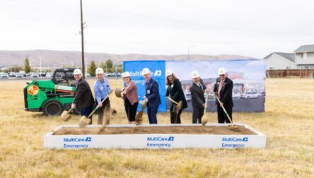 MultiCare team lines up with shovels to officially break ground on construction.