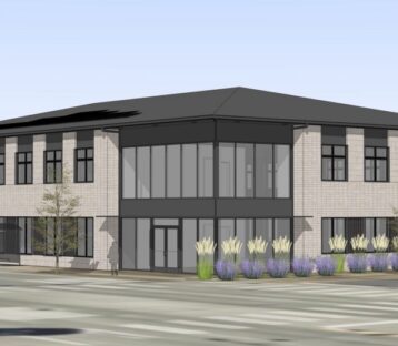 two-story rendering of the future therapy center building depicts a freestanding structure with floor-to-ceiling lobby windows lined by landscaping along one side.
