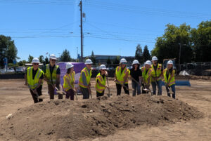 Members of the therapy team, project team, and the Mary Bridge Brigade ply shovels into purple sand, marking the beginning of work on Mary Bridge Children’s Therapy Services – Tacoma. 