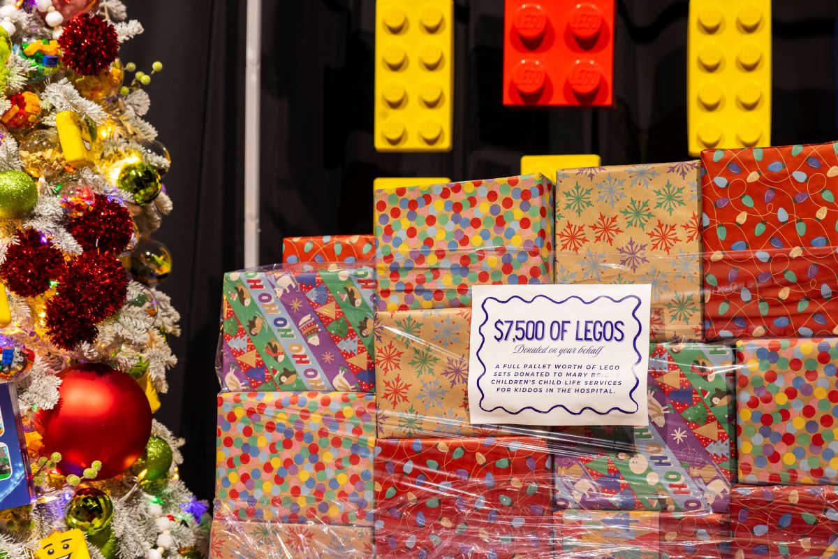 A mountain of LEGO sets festively wrapped in vibrant primary colors form a pallet of fun to be donated to patients on behalf of the Child Life Services team at Mary Bridge Children's Hospital.