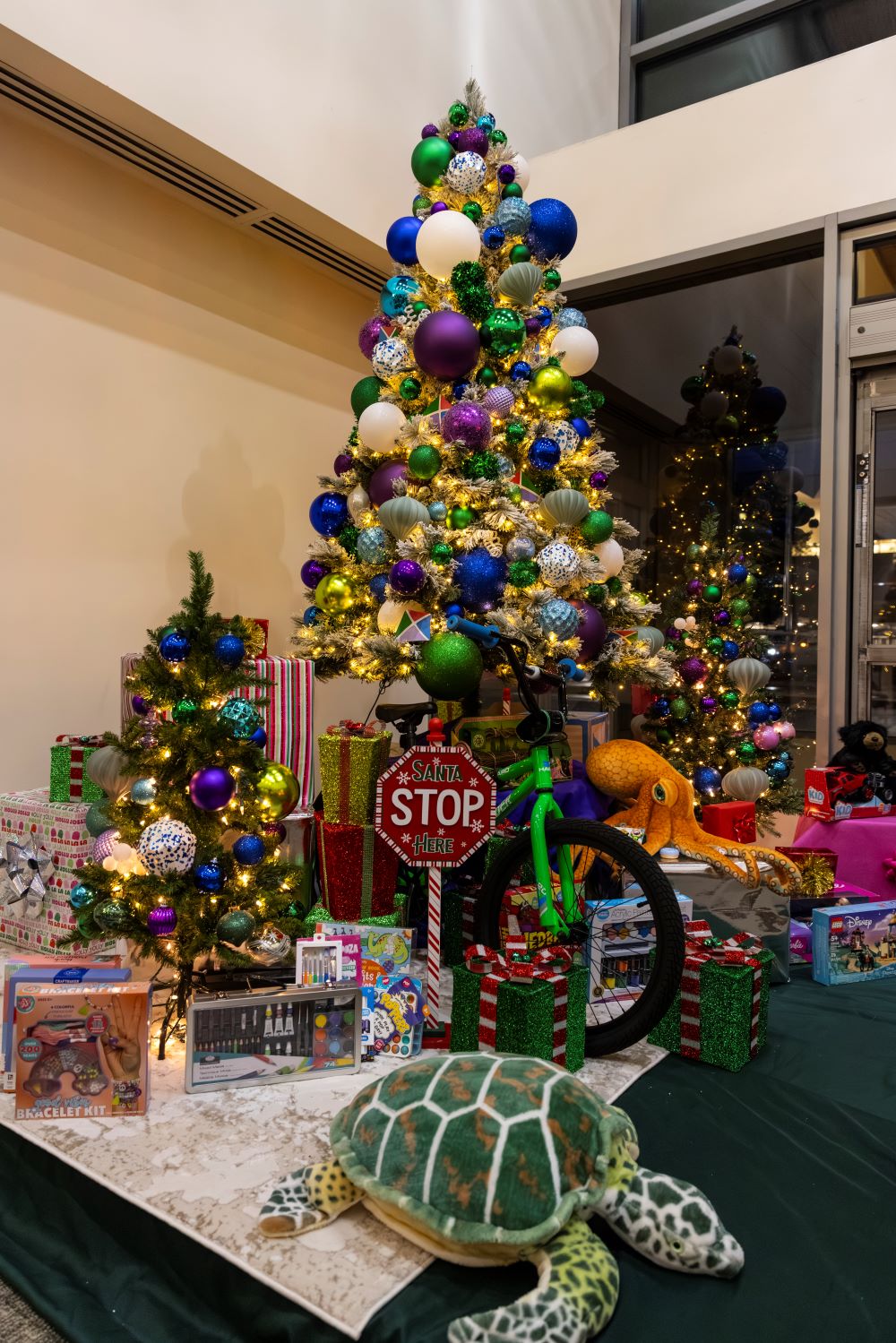 A sparkling holiday tree remains in the Tacoma General Hospital lobby through January, dressed in Mary Bridge Children's blues, greens and purples and flush with children's toys and hi-visibility construction accoutrements.