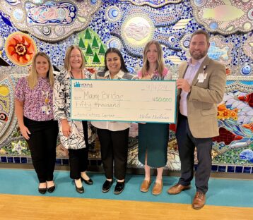 Mary Bridge Leadership holds donation check for $50,000 from Molina