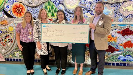 Mary Bridge Leadership holds donation check for $50,000 from Molina