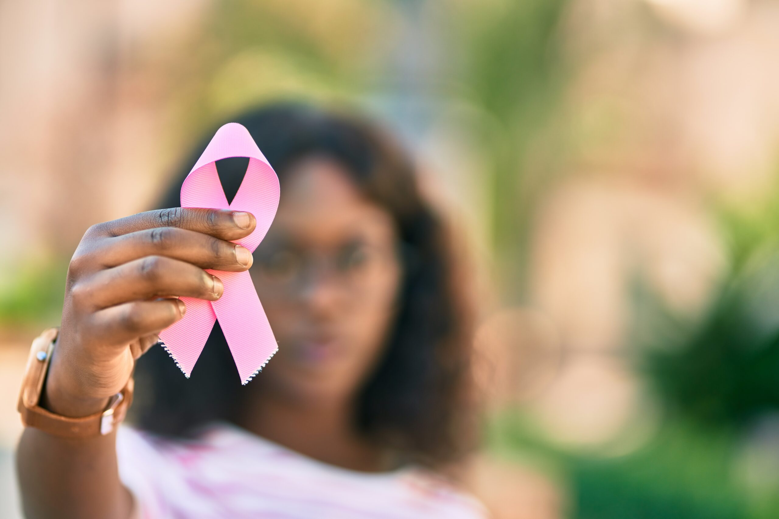 Woman holding a pink ribbon