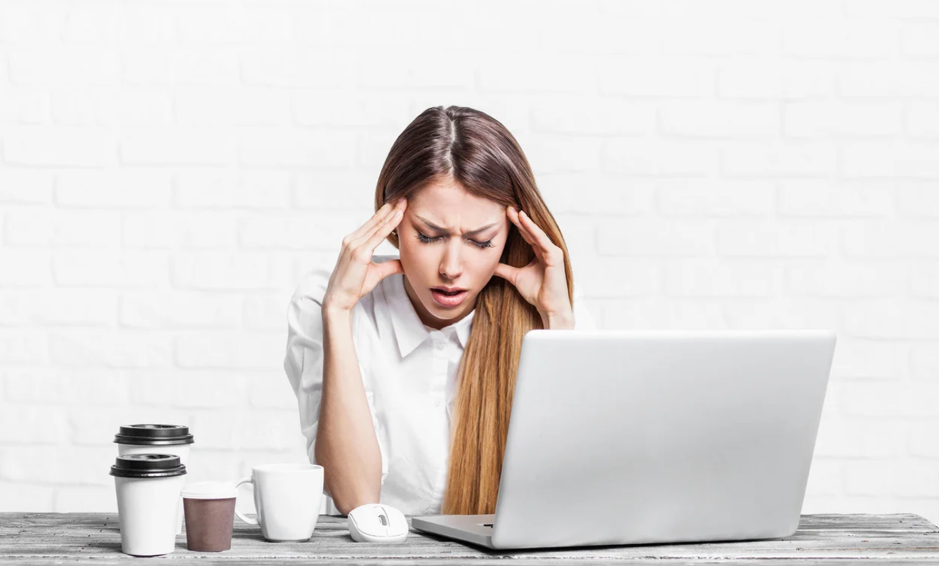 Woman looking stressed in front of laptop
