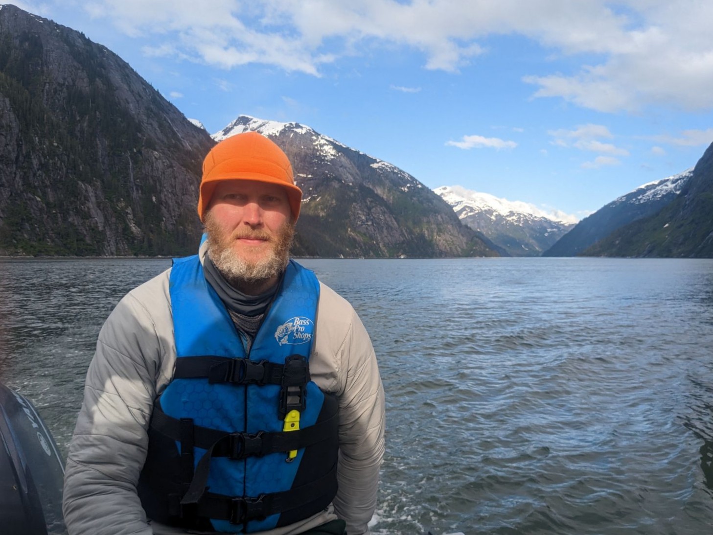 A man wearing a helmet on a lake.