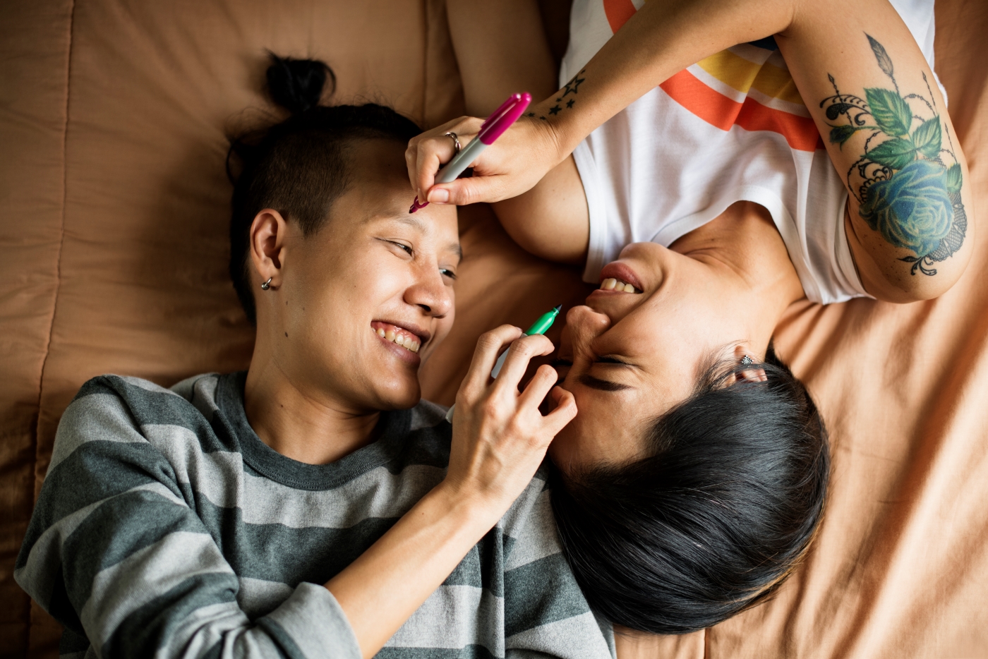 Two people laying in bed.