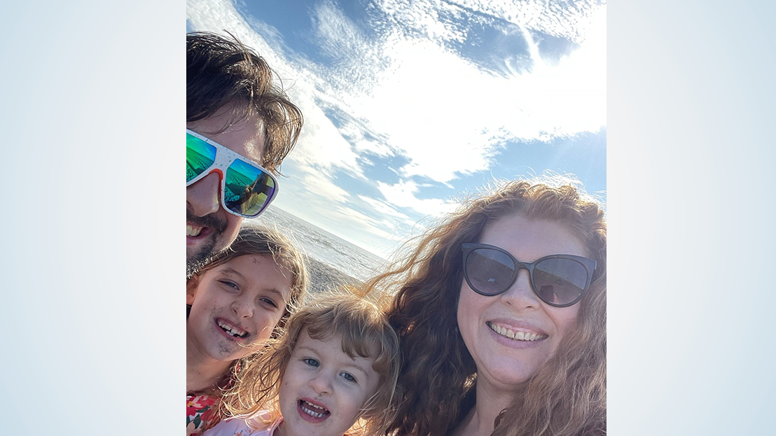 Close-up of smiling family on beach