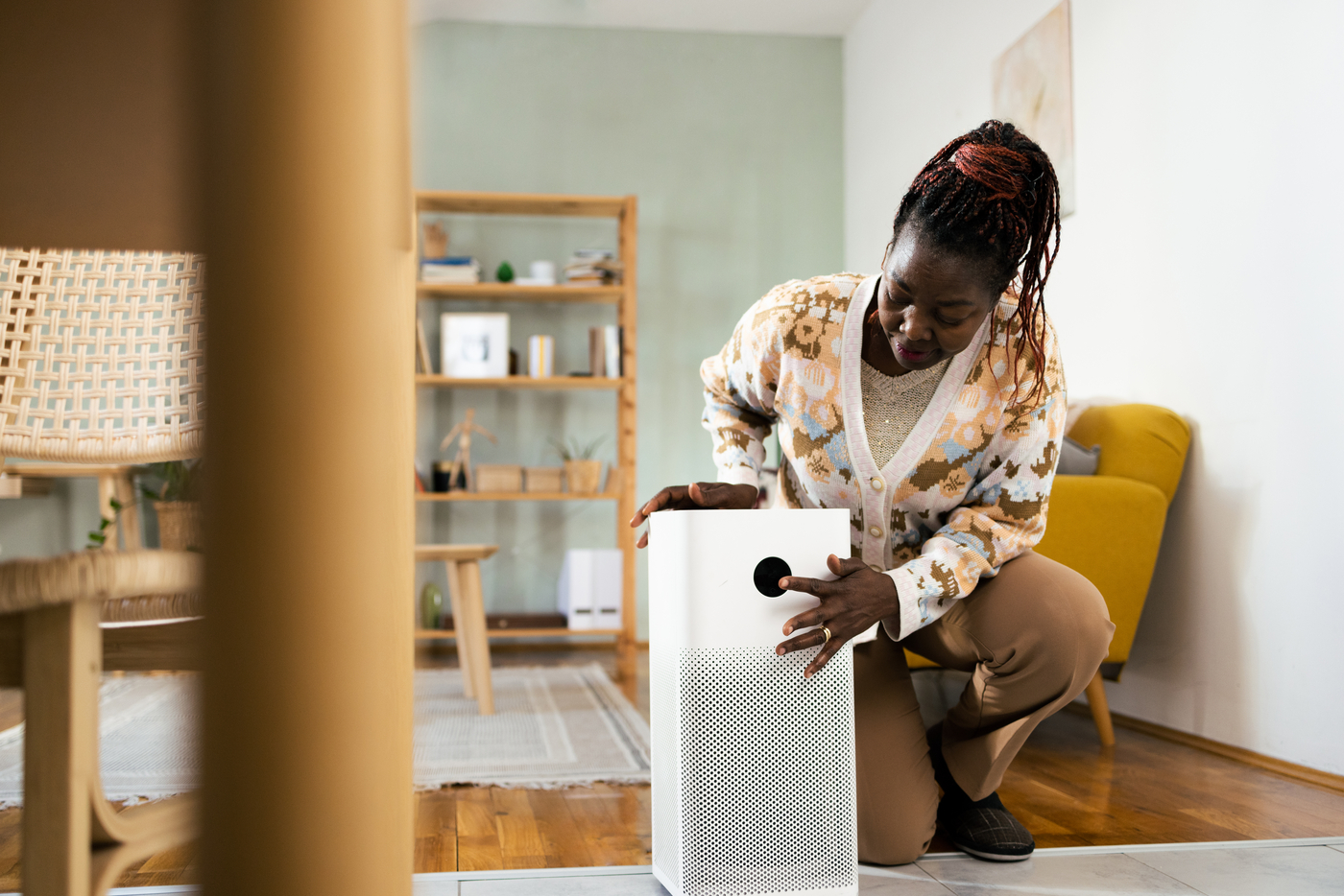 Woman presses button on air purifier