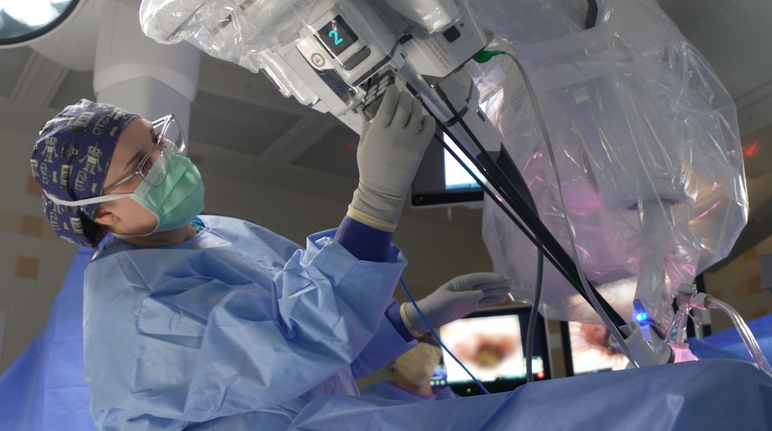 Video still of a surgeon performing robotic surgery
